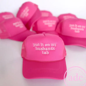 Put It On My Husbands Tab Trucker Hat