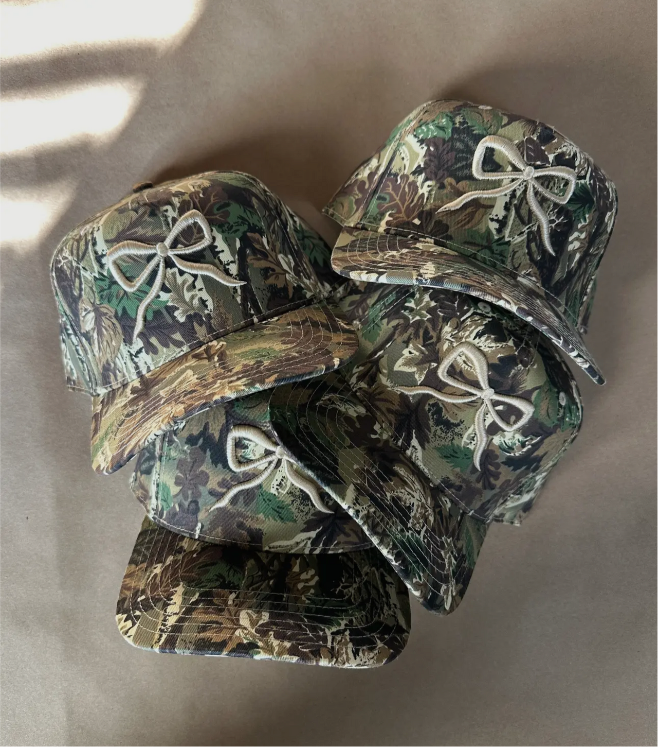 Camo cream bow trucker