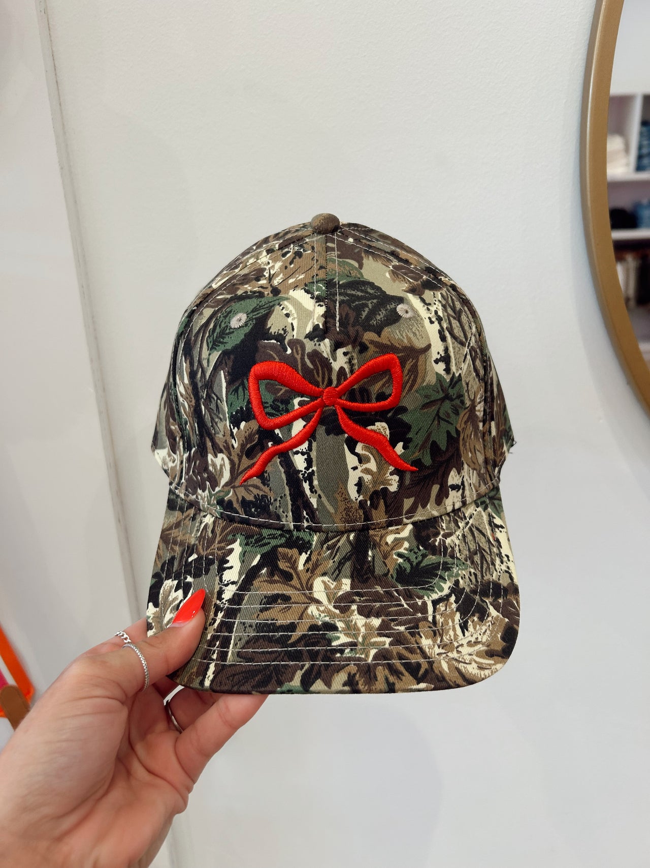 Camo red bow trucker